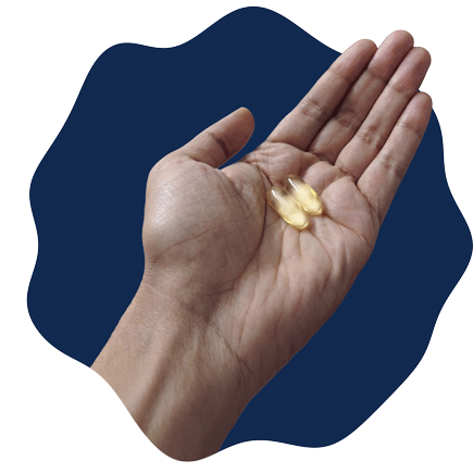 A hand holding two softgels